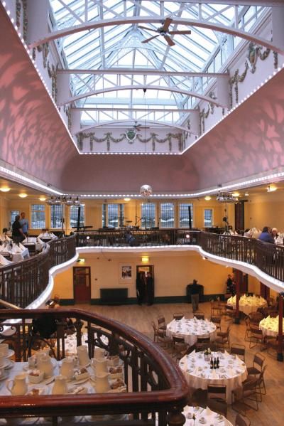 View of ground floor of Winter Garden from balcony with tables set up for a wedding